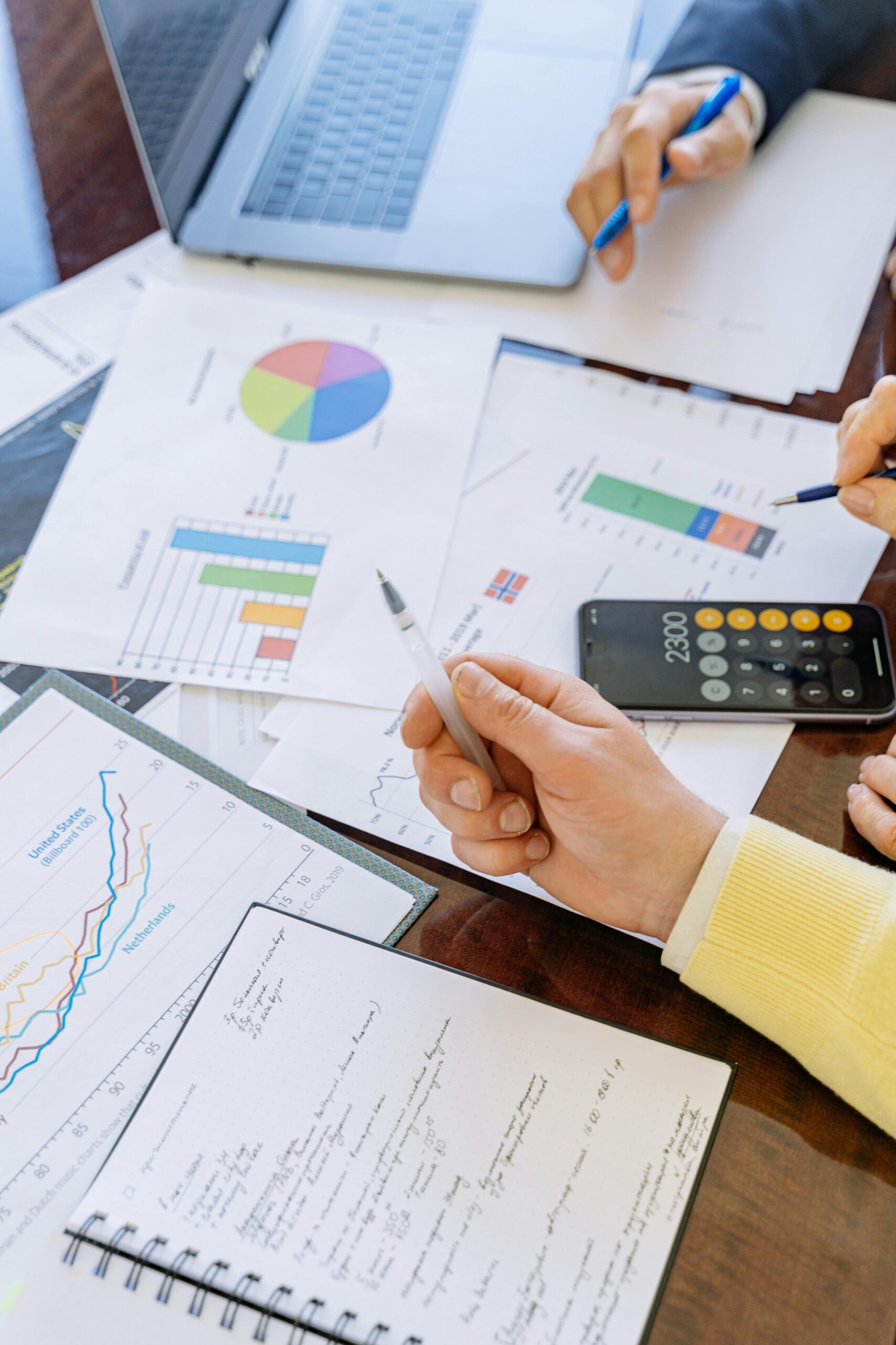 How to Avoid Common Pitfalls in Financial Reporting: A Director’s Guide A close-up of businesspeople analyzing financial data and charts during a meeting.