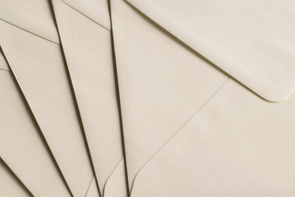 A close-up photo of beige envelopes arranged on a neutral background, ideal for stationery themes.
