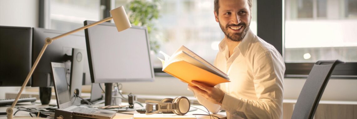 A relaxed businessman enjoying a break in his bright, contemporary office environment.